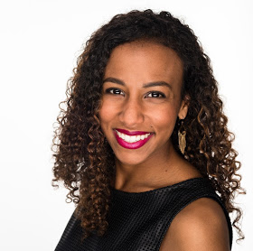 This is a profile picture of Victoria. She is a brown girl with curly hair and nice pink lipstick in this headshot. 